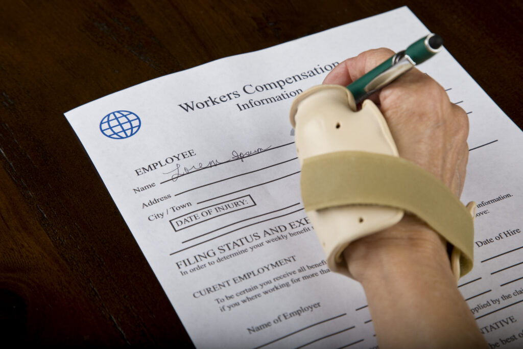someone with a hand cast filing a workers' compensation claim